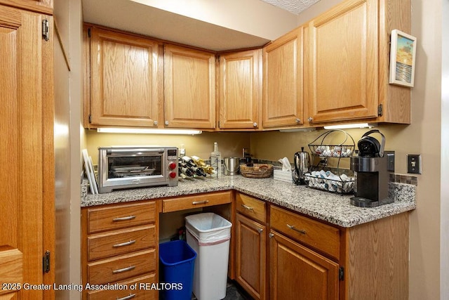 kitchen with light stone countertops and a toaster