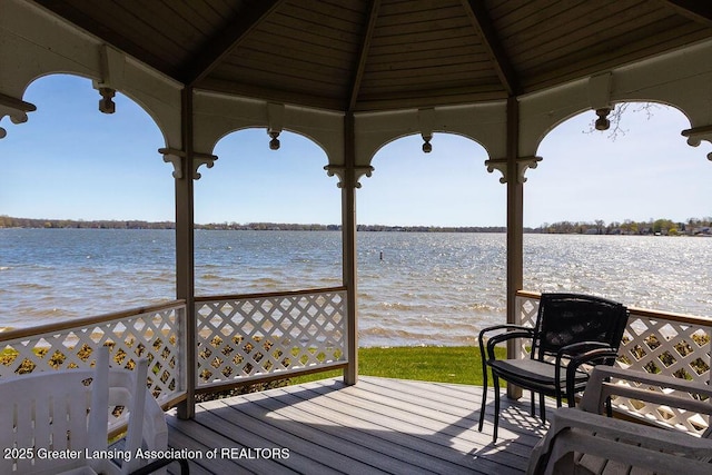 wooden deck featuring a gazebo and a water view