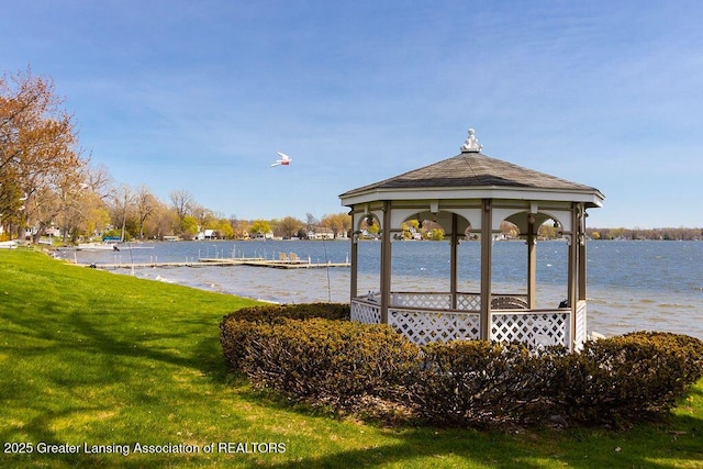 view of community with a gazebo, a water view, and a yard