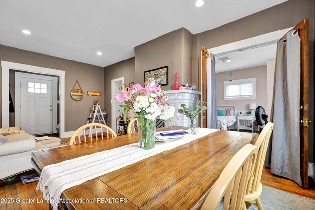 dining space with recessed lighting and wood finished floors