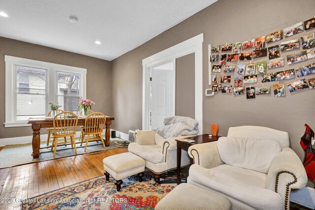 living room featuring wood-type flooring, recessed lighting, and baseboards
