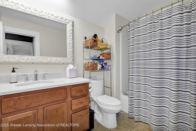bathroom featuring tile patterned floors, shower / bath combo, vanity, and toilet