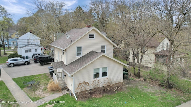 view of side of property featuring roof with shingles