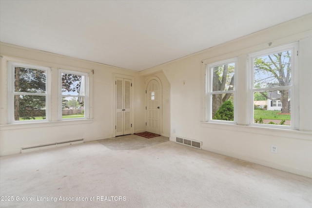12102 Rupp Rd, Grand Ledge, MI 48837 - carpeted entryway with a baseboard radiator and baseboards
