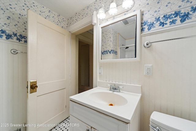 12102 Rupp Rd, Grand Ledge, MI 48837 - bathroom with wallpapered walls, toilet, vanity, and a shower