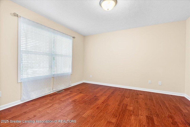 609 E Avocet Dr, East Lansing, MI 48823 - spare room with wood finished floors and baseboards