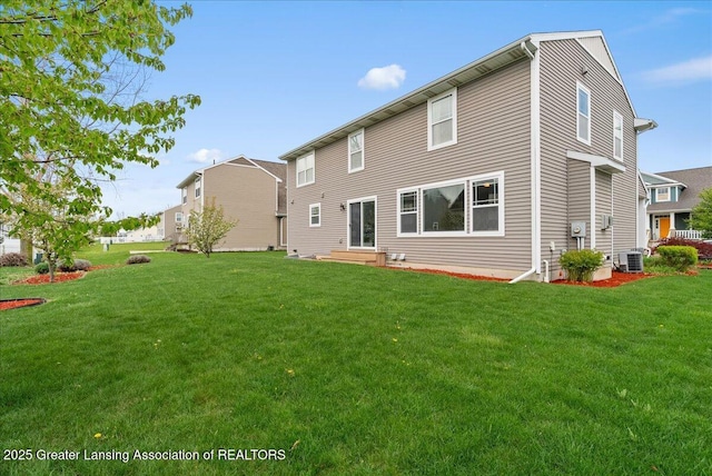 609 E Avocet Dr, East Lansing, MI 48823 - rear view of house with central air condition unit and a lawn