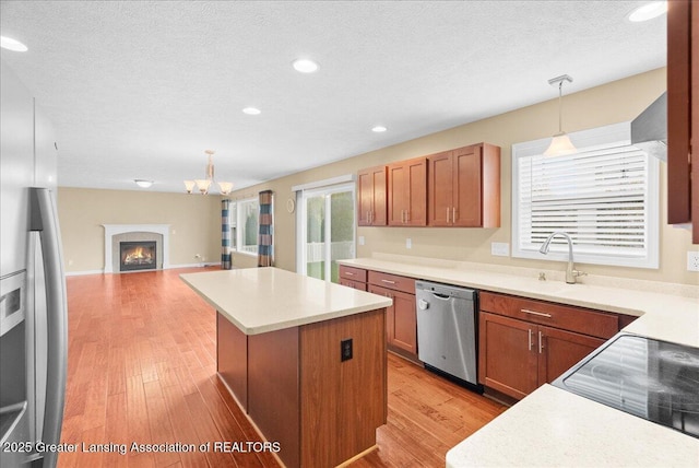 609 E Avocet Dr, East Lansing, MI 48823 - kitchen featuring stainless steel appliances, a center island, decorative light fixtures, a chandelier, and recessed lighting