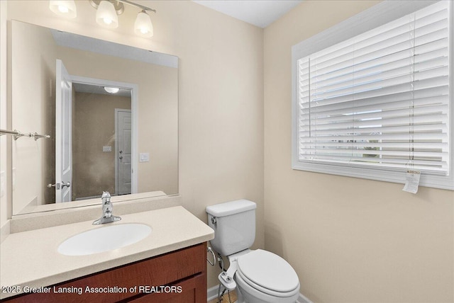 609 E Avocet Dr, East Lansing, MI 48823 - bathroom featuring toilet, vanity, and baseboards