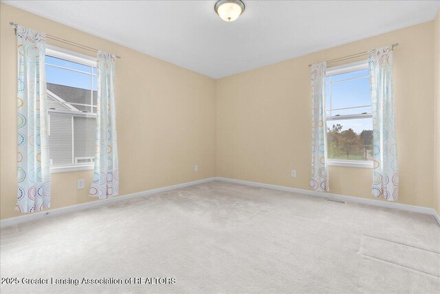 609 E Avocet Dr, East Lansing, MI 48823 - spare room with carpet, baseboards, and plenty of natural light