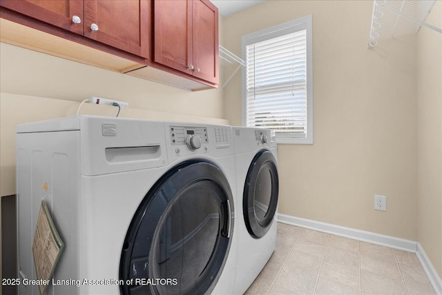 609 E Avocet Dr, East Lansing, MI 48823 - laundry room featuring washing machine and clothes dryer, cabinet space, baseboards, and light tile patterned flooring