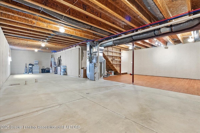 609 E Avocet Dr, East Lansing, MI 48823 - unfinished basement featuring stairway and heating unit