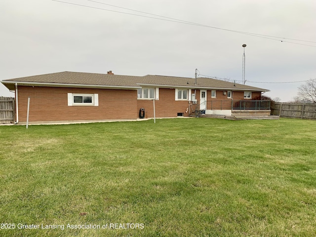 3156 E M-21 Rd, Saint Johns, MI 48879 - rear view of property featuring fence, a deck, a lawn, and brick siding