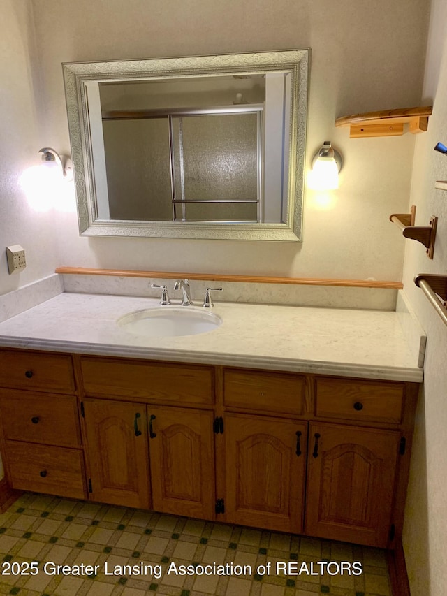 3156 E M-21 Rd, Saint Johns, MI 48879 - bathroom with tile patterned floors, an enclosed shower, and vanity