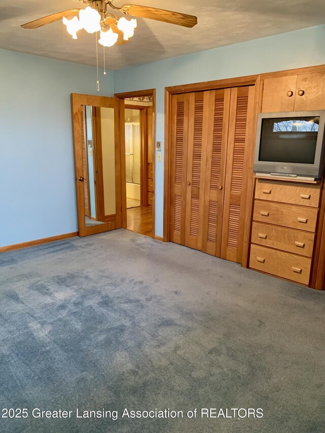 3156 E M-21 Rd, Saint Johns, MI 48879 - unfurnished bedroom featuring a closet, ceiling fan, carpet floors, and baseboards