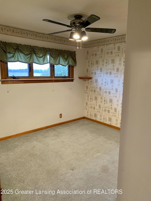 3156 E M-21 Rd, Saint Johns, MI 48879 - unfurnished room with baseboards, ceiling fan, and carpet