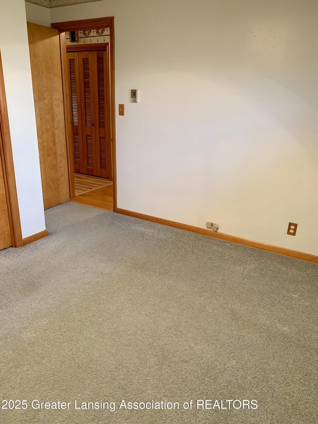 3156 E M-21 Rd, Saint Johns, MI 48879 - unfurnished room featuring carpet floors and baseboards