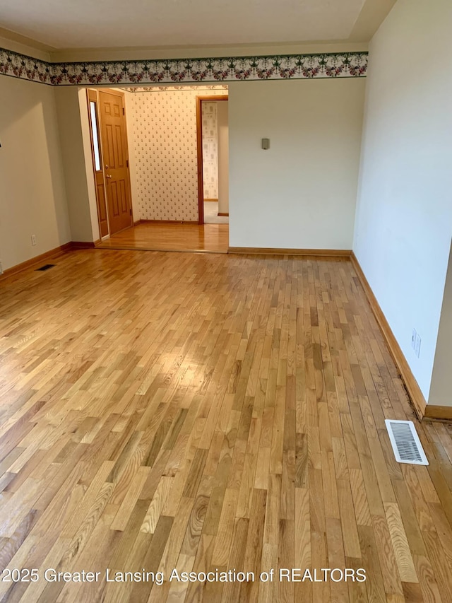 3156 E M-21 Rd, Saint Johns, MI 48879 - spare room with visible vents, light wood-style flooring, and baseboards