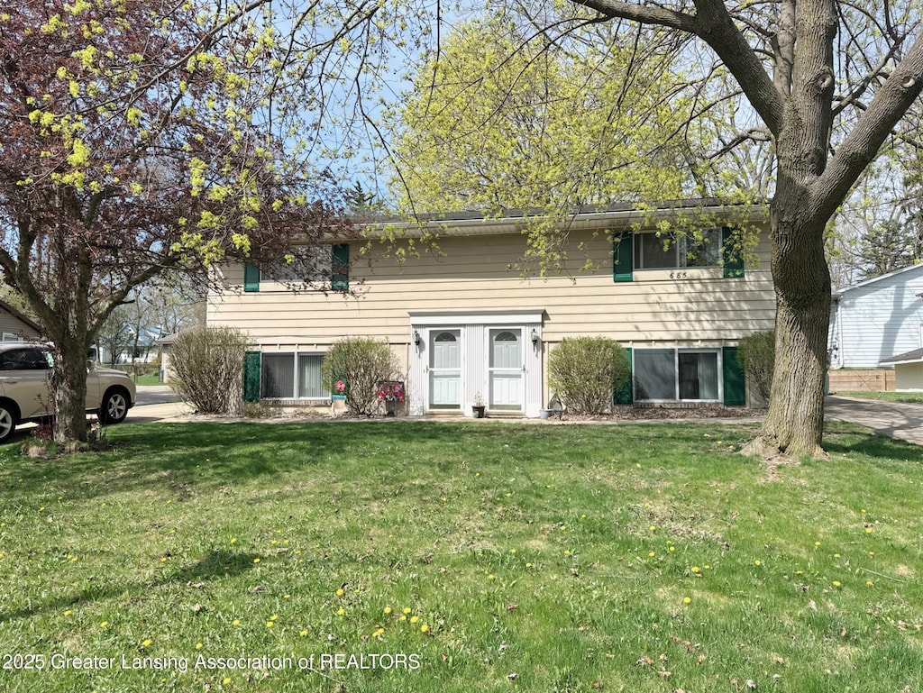 bi-level home with a front yard