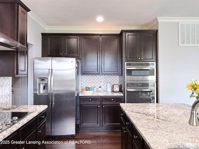 2718 Kittansett Dr, Okemos, MI 48864 - kitchen with appliances with stainless steel finishes, dark wood-style floors, tasteful backsplash, ornamental molding, and dark brown cabinets