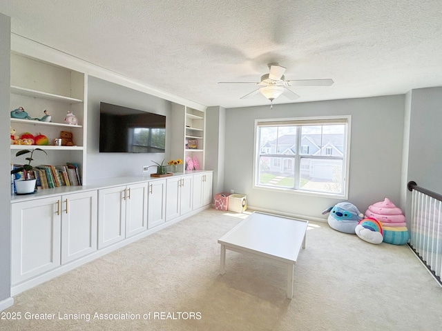 2718 Kittansett Dr, Okemos, MI 48864 - game room featuring a textured ceiling, carpet flooring, ceiling fan, and built in shelves