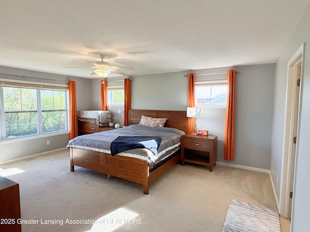 2718 Kittansett Dr, Okemos, MI 48864 - bedroom with multiple windows, light carpet, and baseboards