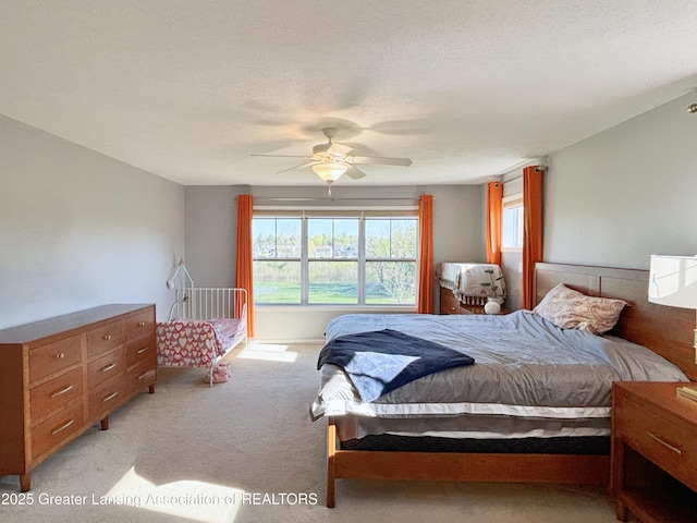 2718 Kittansett Dr, Okemos, MI 48864 - bedroom with light carpet and a ceiling fan