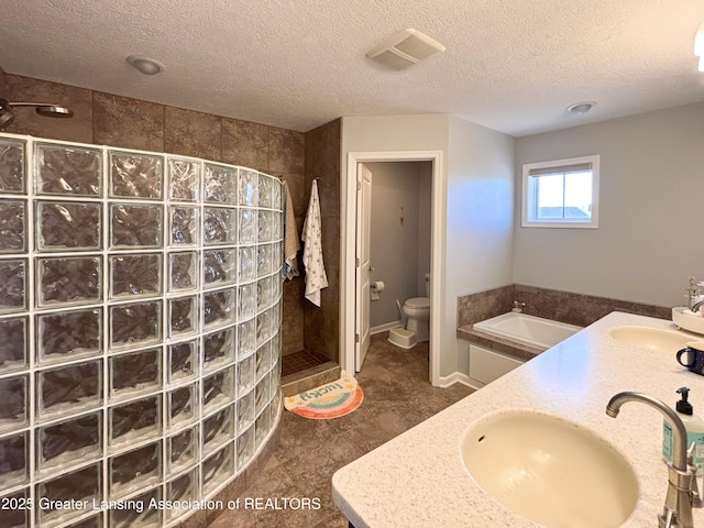 2718 Kittansett Dr, Okemos, MI 48864 - full bathroom with walk in shower, toilet, a textured ceiling, and double vanity