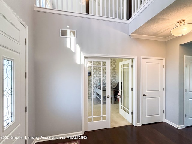 2718 Kittansett Dr, Okemos, MI 48864 - foyer with french doors, wood finished floors, baseboards, and a towering ceiling