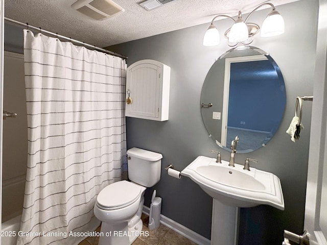 2718 Kittansett Dr, Okemos, MI 48864 - full bath with a textured ceiling, toilet, tile patterned floors, shower / tub combo with curtain, and baseboards
