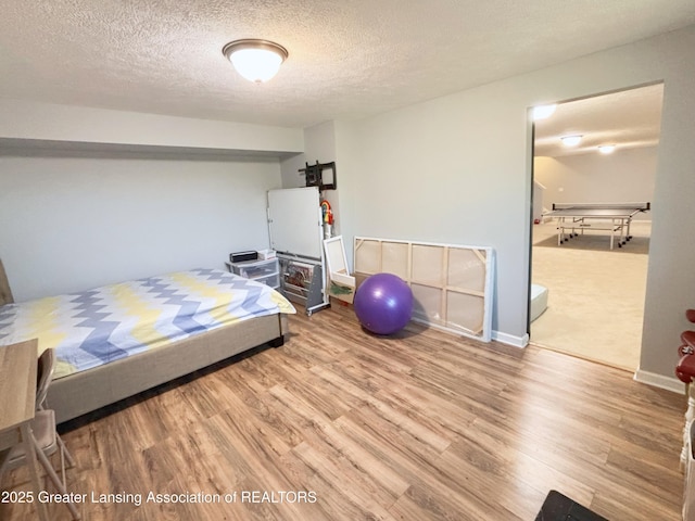 2718 Kittansett Dr, Okemos, MI 48864 - bedroom with wood finished floors and a textured ceiling