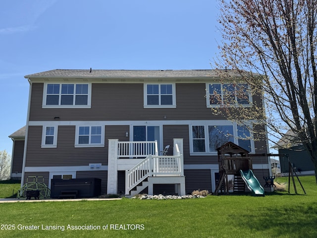 2718 Kittansett Dr, Okemos, MI 48864 - rear view of property featuring a yard, a playground, stairs, and a wooden deck