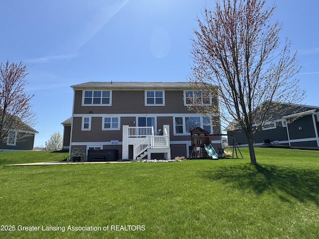 2718 Kittansett Dr, Okemos, MI 48864 - rear view of house with a playground, a lawn, and stairs