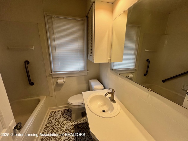 bathroom with tile patterned floors, toilet, shower / tub combination, and vanity
