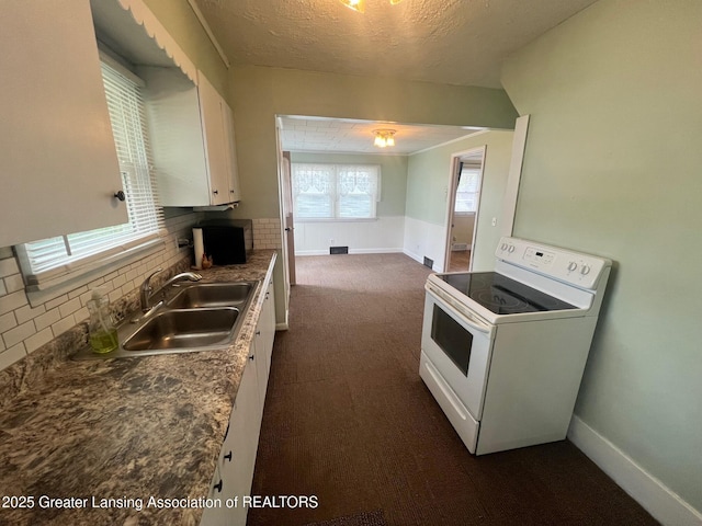 kitchen featuring decorative backsplash, dark colored carpet, white cabinets, a sink, and white electric range oven