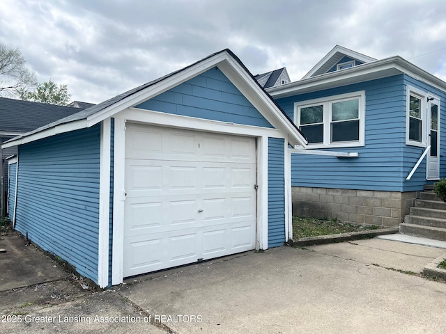 exterior space with an outbuilding and concrete driveway