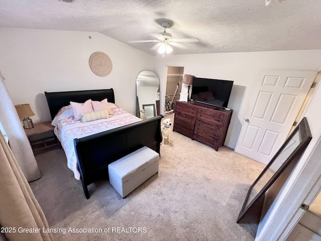 bedroom featuring ceiling fan, a textured ceiling, light colored carpet, and vaulted ceiling
