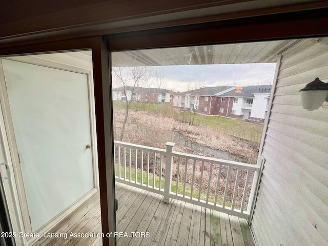 doorway to outside featuring a residential view and wood-type flooring