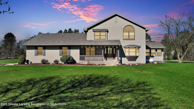 11267 Jarvis Hwy, Dimondale, MI 48821 - traditional home with a lawn, roof with shingles, and covered porch