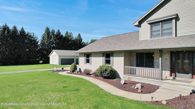 11267 Jarvis Hwy, Dimondale, MI 48821 - view of front of property featuring a porch, roof with shingles, an outbuilding, and a front yard
