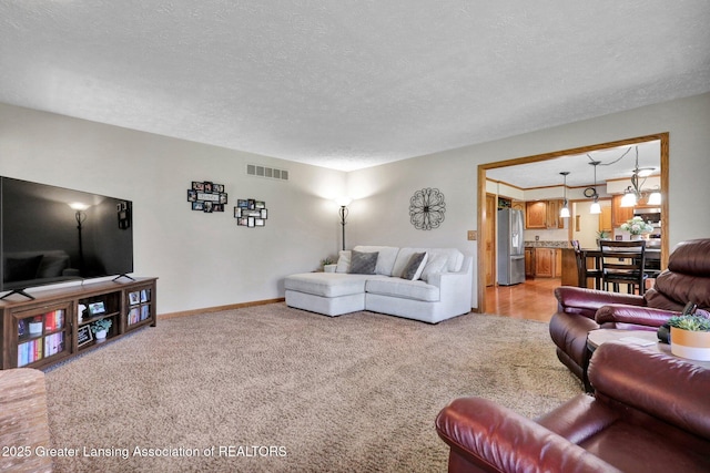 11267 Jarvis Hwy, Dimondale, MI 48821 - living area with light colored carpet, a textured ceiling, and visible vents
