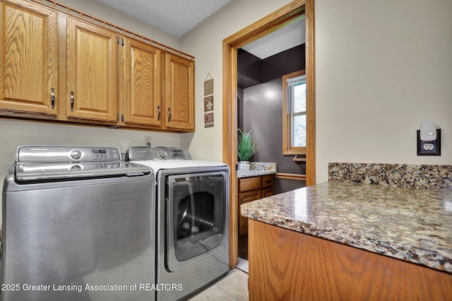 11267 Jarvis Hwy, Dimondale, MI 48821 - laundry area with cabinet space, separate washer and dryer, and light tile patterned flooring