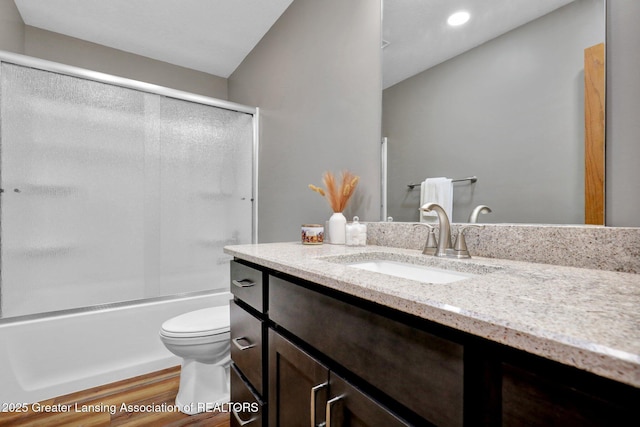 11267 Jarvis Hwy, Dimondale, MI 48821 - bathroom with vanity, wood finished floors, toilet, recessed lighting, and enclosed tub / shower combo