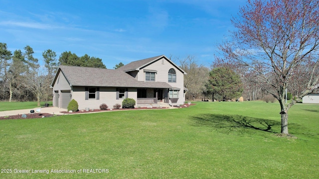 11267 Jarvis Hwy, Dimondale, MI 48821 - view of front of home with a front lawn, covered porch, roof with shingles, an attached garage, and driveway