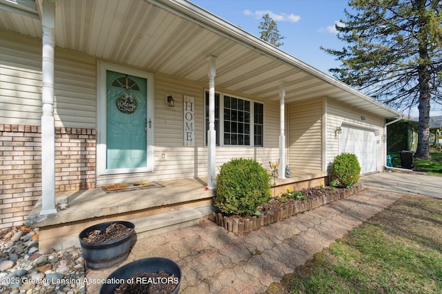 1310 Schavey Rd, Dewitt, MI 48820 - doorway to property featuring a garage, a porch, and driveway