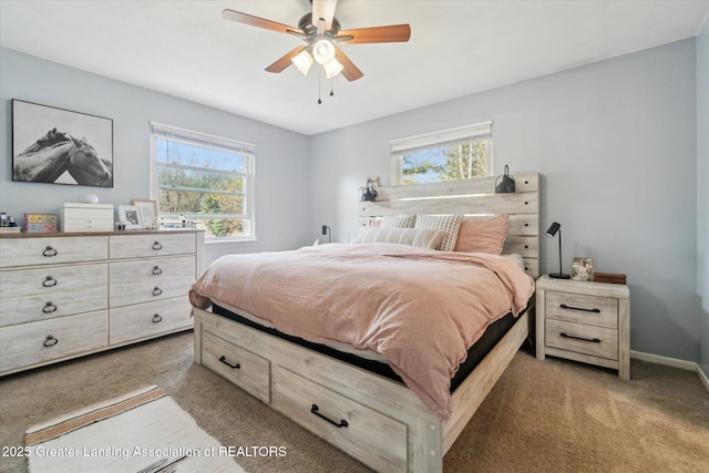 1310 Schavey Rd, Dewitt, MI 48820 - bedroom featuring multiple windows, baseboards, a ceiling fan, and light carpet