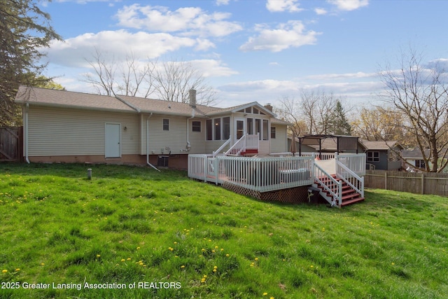 1310 Schavey Rd, Dewitt, MI 48820 - rear view of house with a wooden deck, a chimney, fence, stairway, and a sunroom