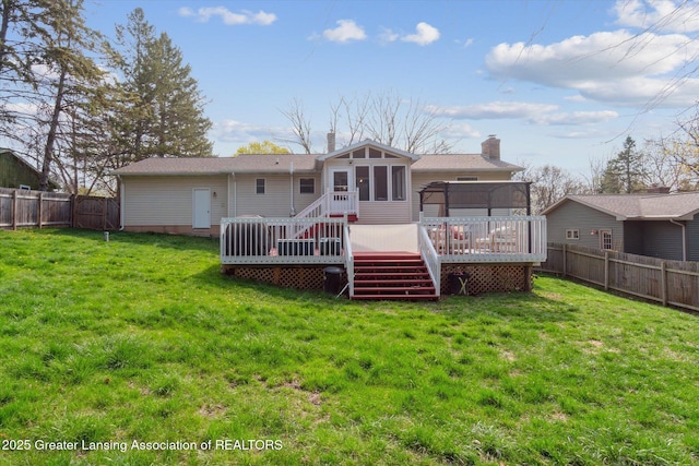 1310 Schavey Rd, Dewitt, MI 48820 - rear view of property with a sunroom, a wooden deck, a fenced backyard, a lawn, and a chimney