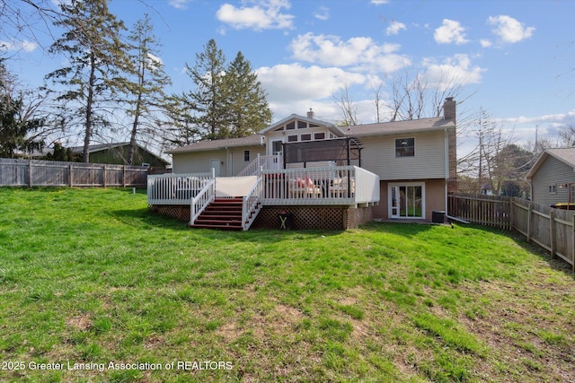 1310 Schavey Rd, Dewitt, MI 48820 - back of property featuring a deck, a yard, a chimney, and a fenced backyard