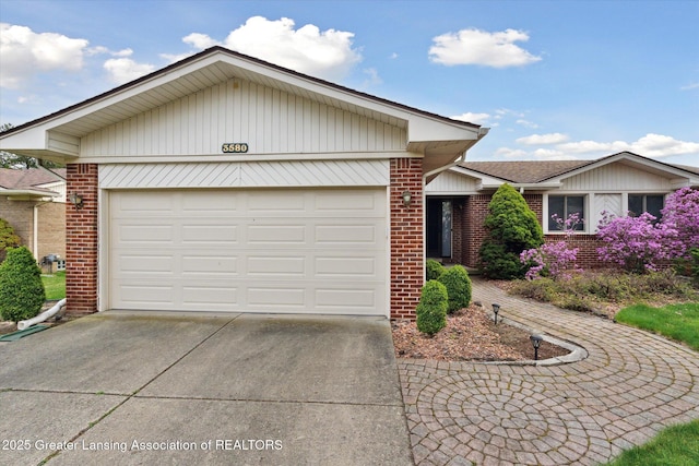 ranch-style house with concrete driveway, an attached garage, and brick siding